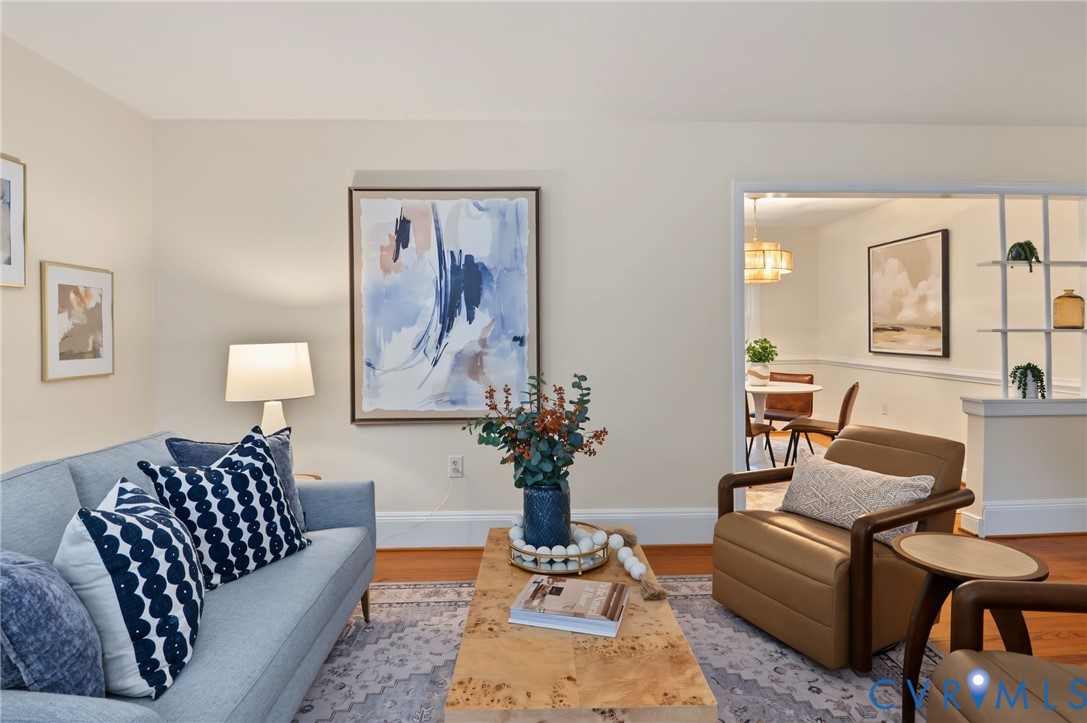 Hardwood flooring, cased opening to dining area, chair rail molding, built-in shelving, and recessed lighting Hardwood flooring, cased opening to dining area, chair rail molding, built-in shelving, and recessed lighting