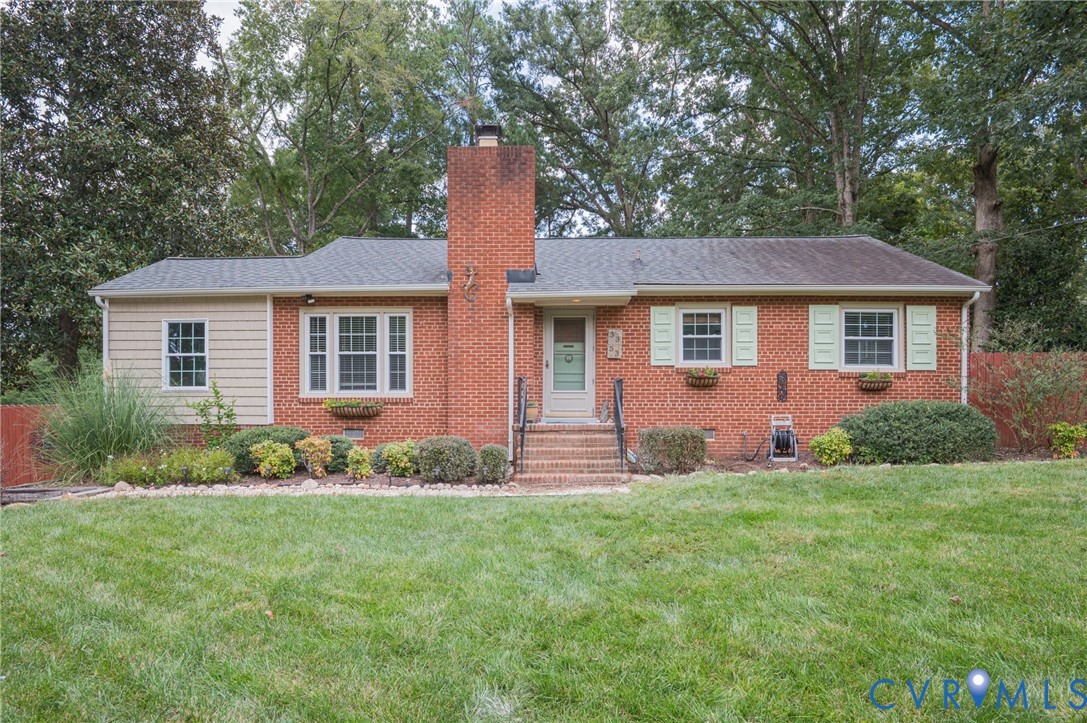 Brick exterior with a prominent chimney and light-colored siding accent