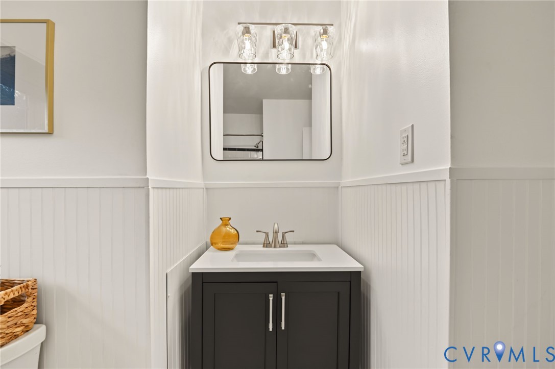 Vanity with white countertop, undermount sink, and brushed nickel faucet