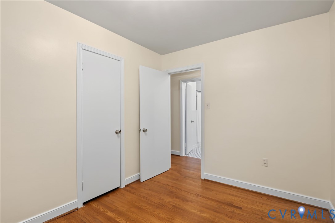 Wood-finish flooring with light-toned walls and white trim