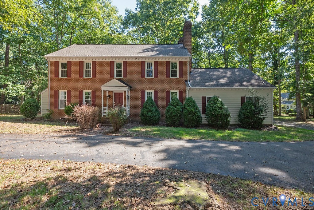 Brick and siding exterior with a front portico