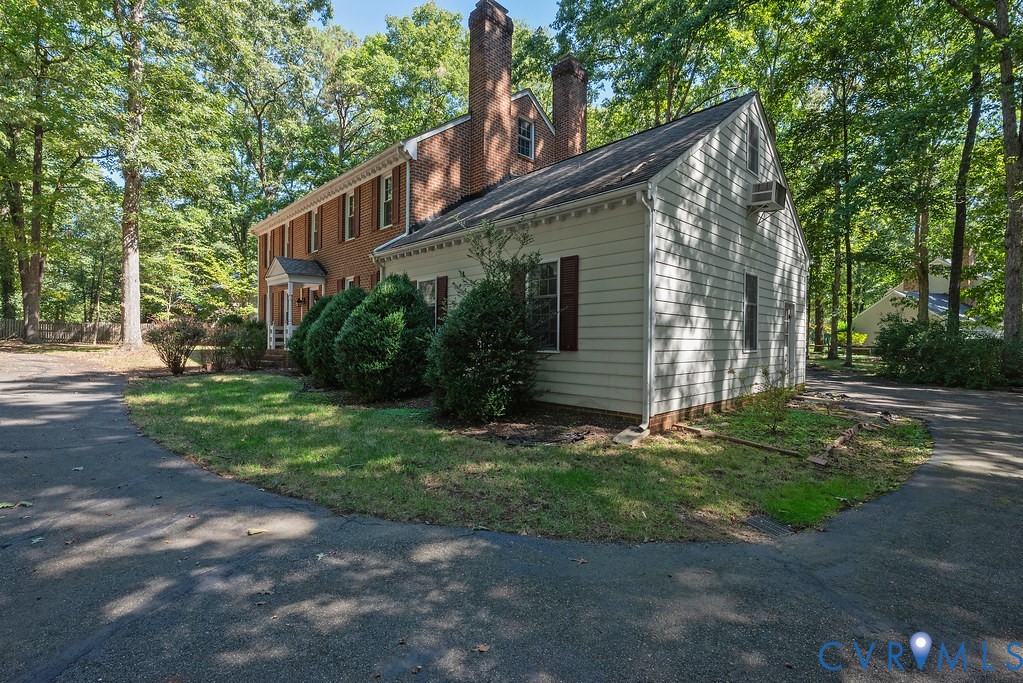 Red brick facade with a white columned portico entry