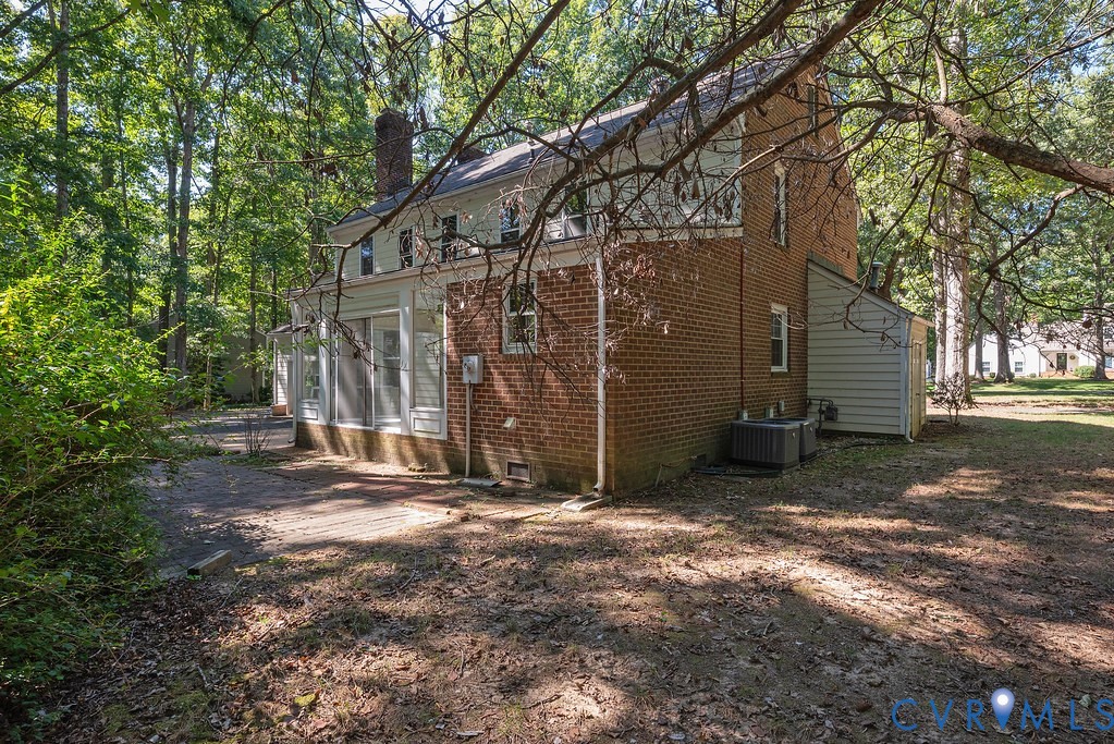 Brick exterior with white siding accents and a screened-in porch
