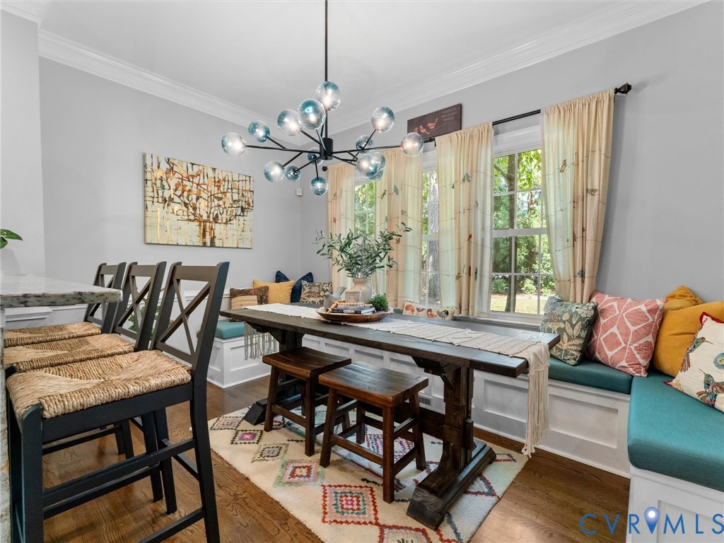 Bar with seating and breakfast nook with built in banquette seating and farmhouse table that conveys