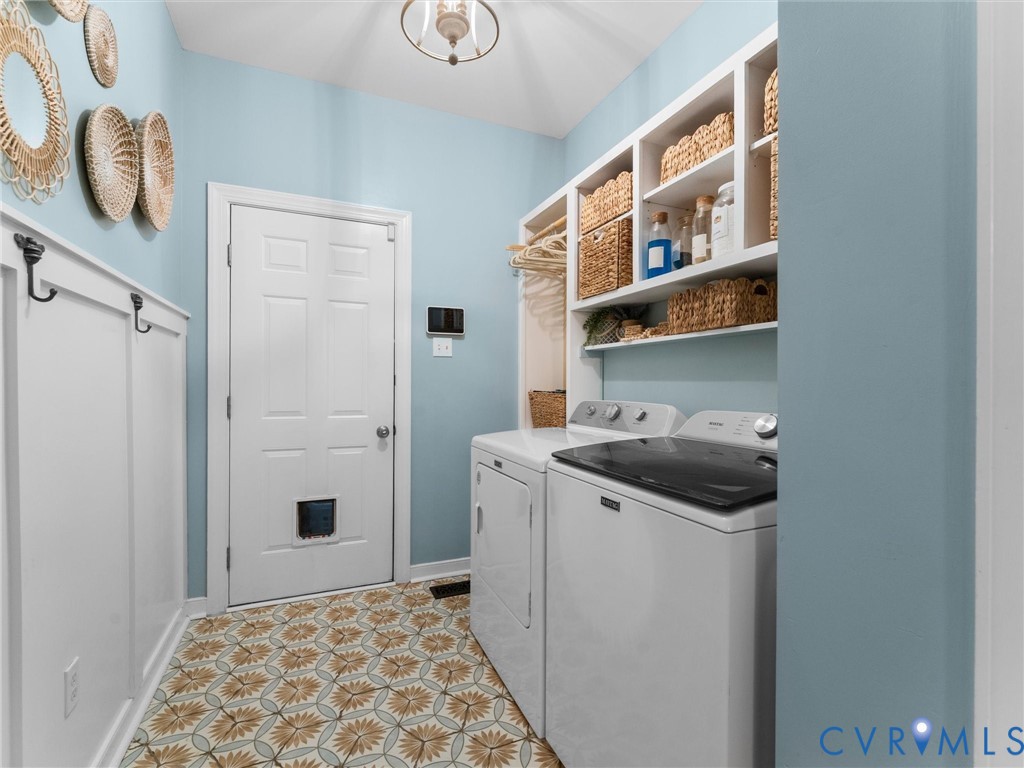 Laundry/Mud room recently updated with new tile , built ins, and wainscotting