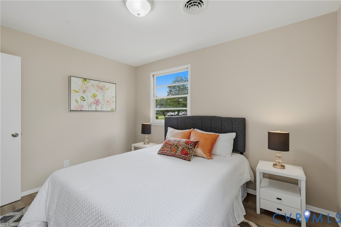 Recessed lighting, wood-finish flooring, and light neutral wall colors