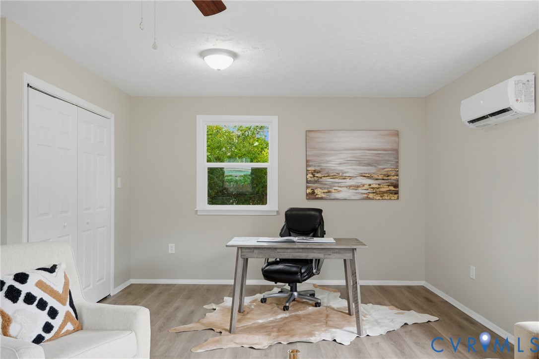 Wood-finish flooring with neutral wall paint and white trim