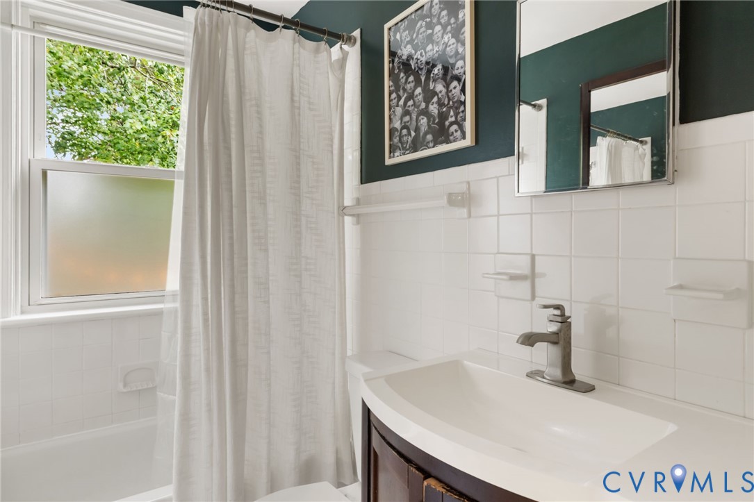 The full bathroom has been updated in just the right ways, keeping the original charm of the home while providing updated fixtures