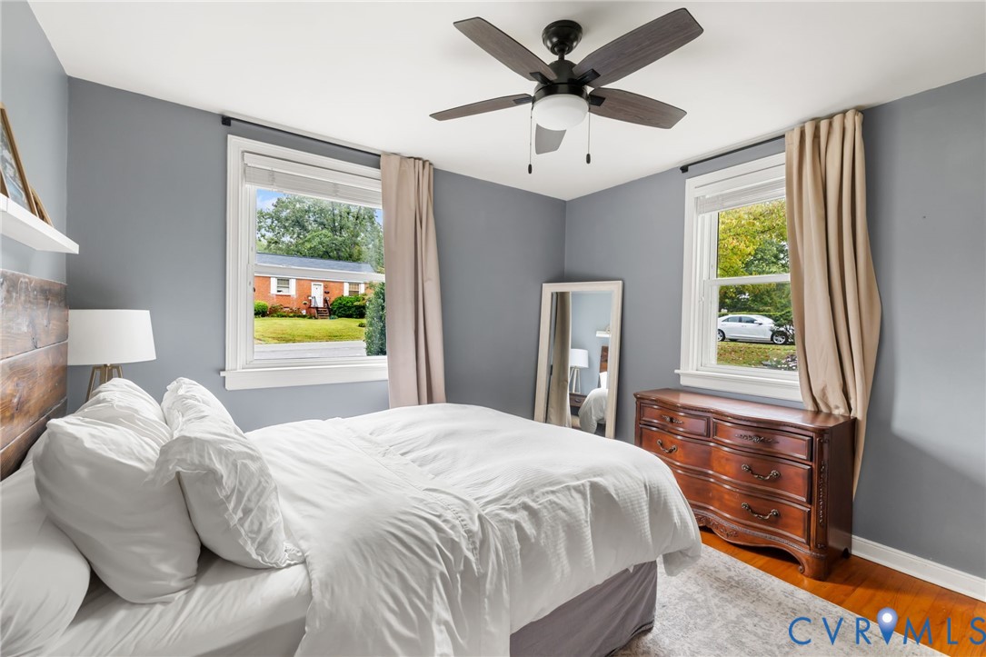 Primary bedroom is soaked in natural light