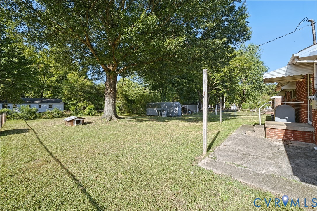Expansive grassy yard with mature trees