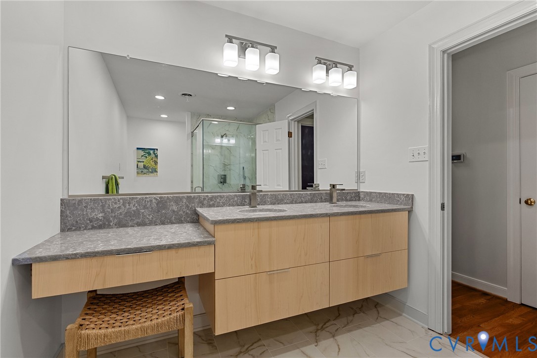 Newly renovated primary bath with zero entry shower and custom quartz double vanity