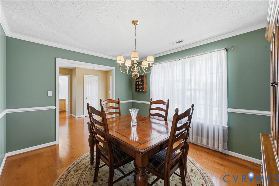 Dedicated dining room with hardwood floors and classic trim, ready for holiday meals and memorable gatherings. Dedicated dining room with hardwood floors and classic trim, ready for holiday meals and memorable gatherings.