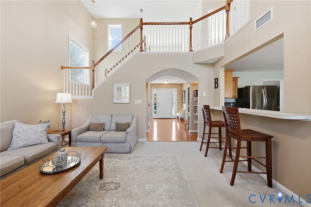 An airy living room brings everyone together with soaring cathedral ceilings and ample natural light An airy living room brings everyone together with soaring cathedral ceilings and ample natural light