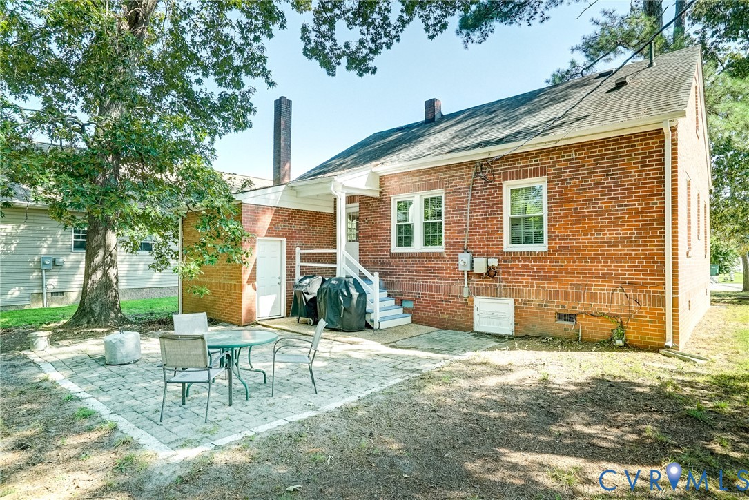 Brick exterior with a gabled roof and white window trim