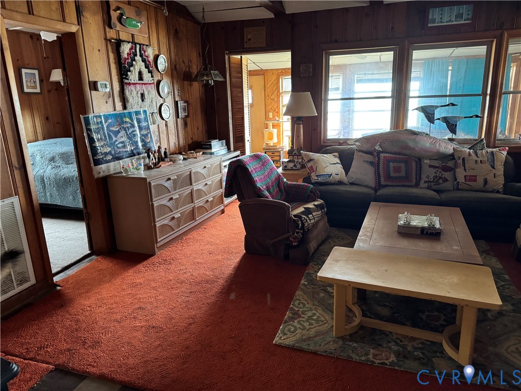Wood-paneled interior walls, wall-to-wall carpeting, and large multi-pane windows