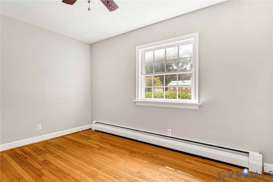 Hardwood flooring, painted walls, white trim, and a ceiling fan