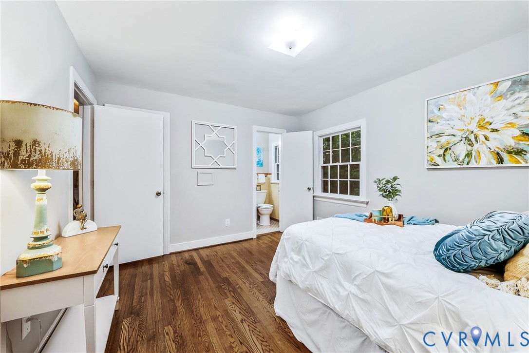 Hardwood flooring throughout, a square paneled window, recessed ceiling lighting, and light-toned wall finishes