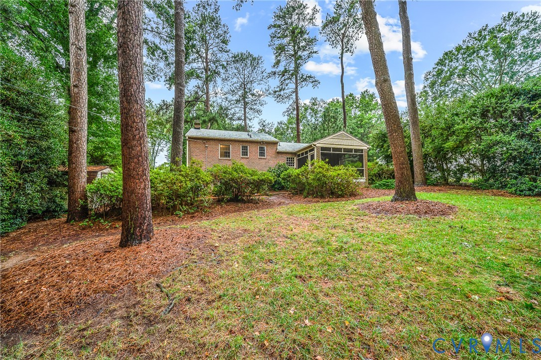 Expansive lawn area with mature trees and established landscaping