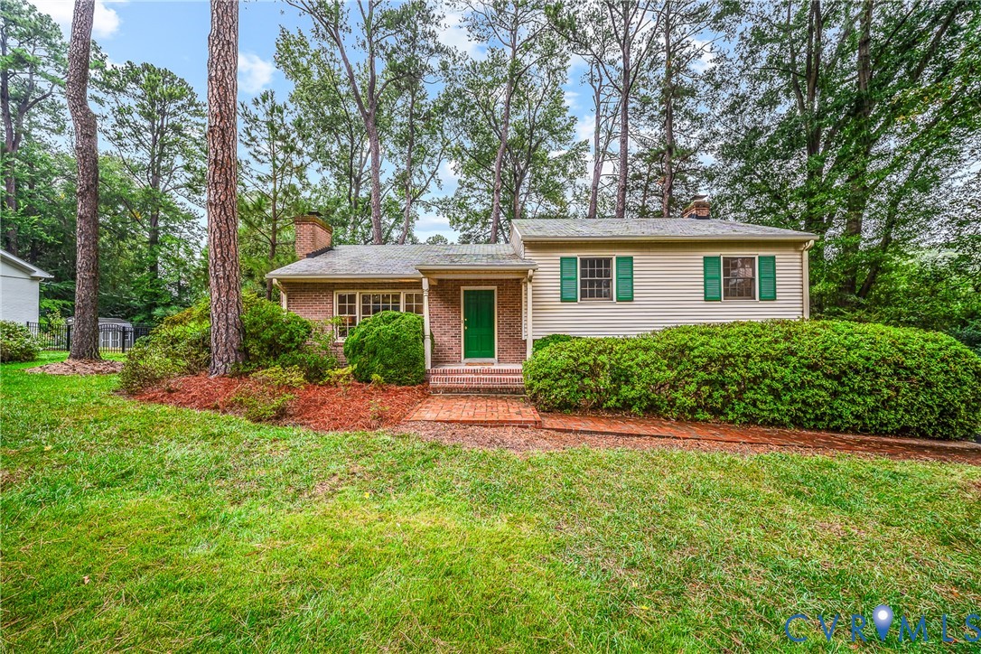 Brick and siding exterior with a green entry door Brick and siding exterior with a green entry door