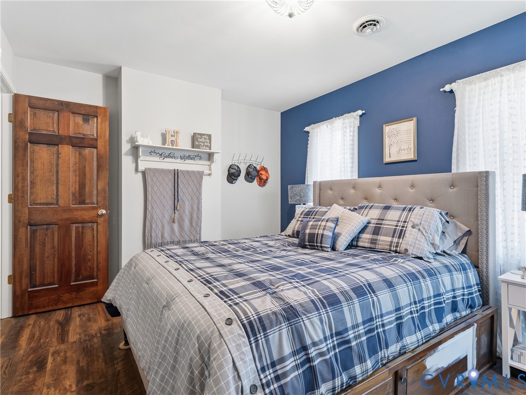 Wood-finish flooring, six-panel solid wood door, and accent wall