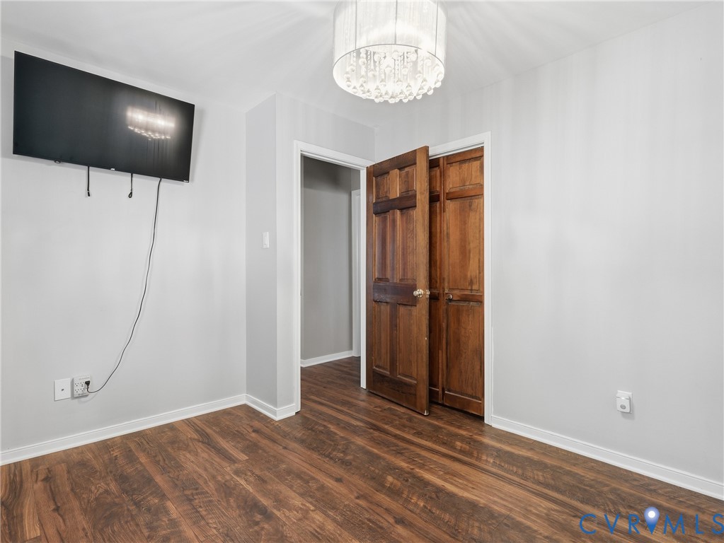Wood-finish flooring, crystal drum pendant lighting, and six-panel natural wood doors