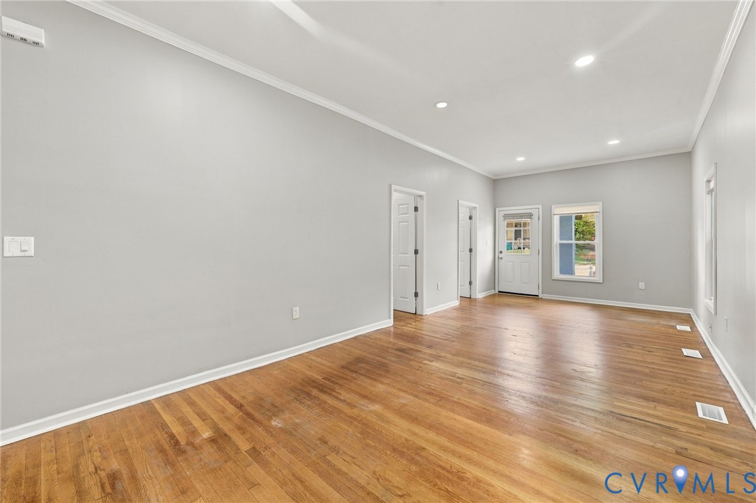 Recessed lighting illuminates the wood-finish flooring