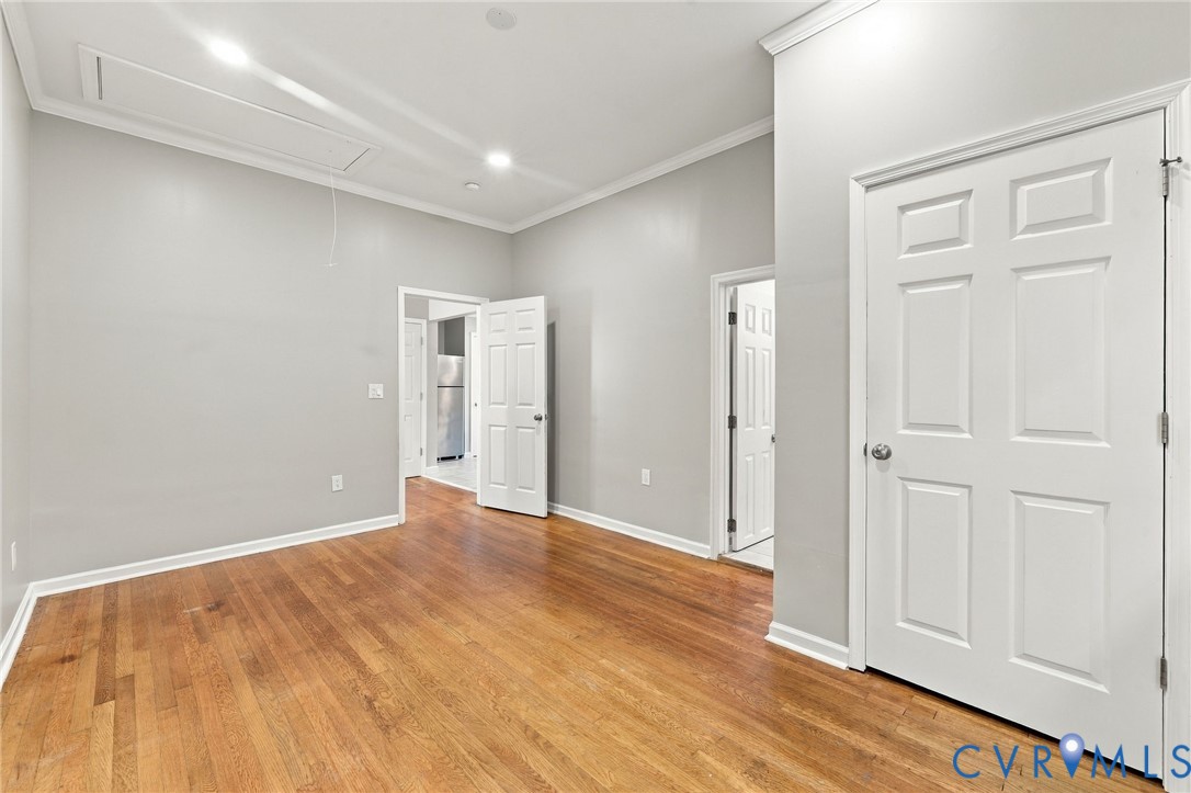 Hardwood flooring, painted walls, crown molding, white doors, recessed lighting