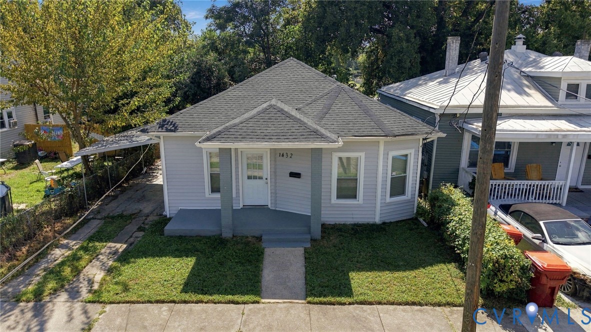 Light gray siding exterior with a dark gray shingle roof