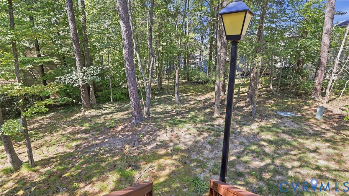 Private wooded lot with mature trees and a sloped terrain