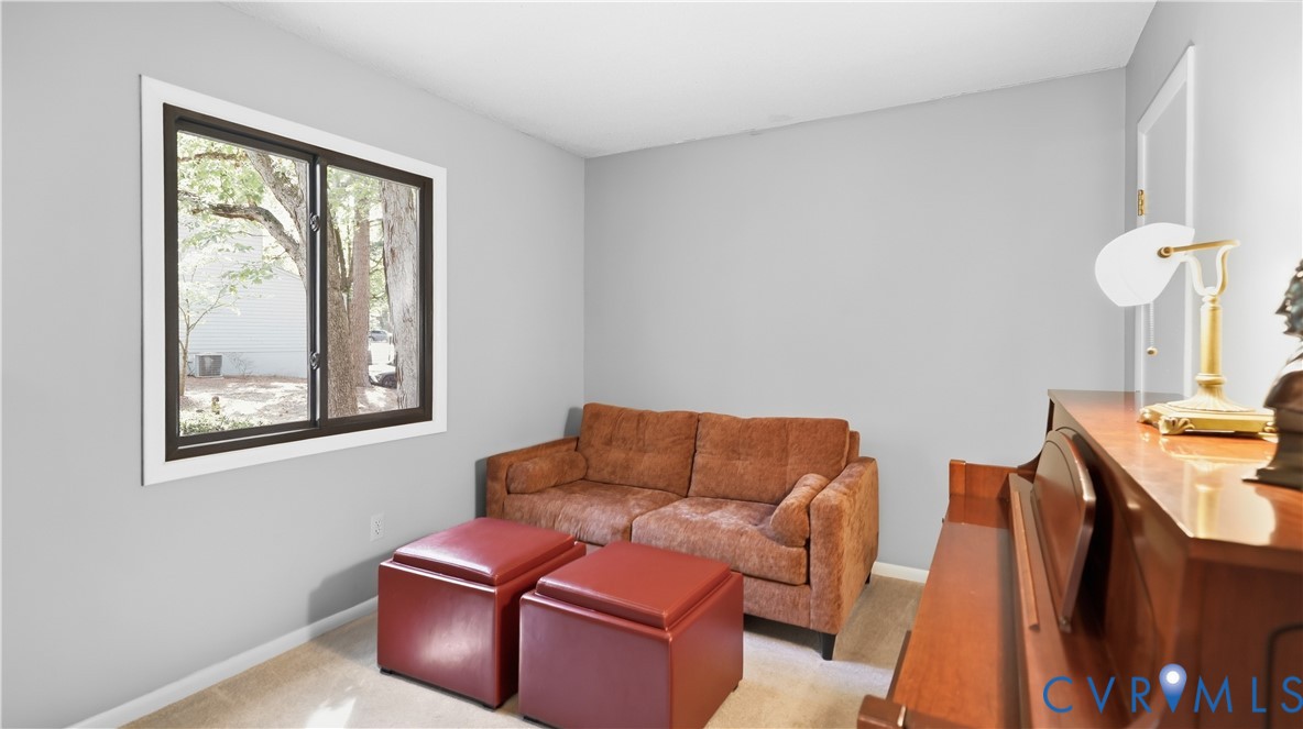 Neutral wall paint, framed window, and carpeted flooring