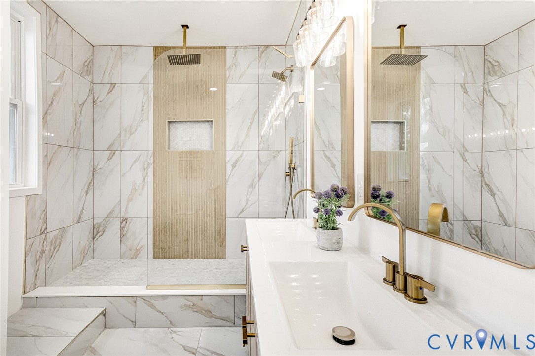 Walk-in shower with full-height tile surround, built-in niche, and ceiling-mounted showerhead