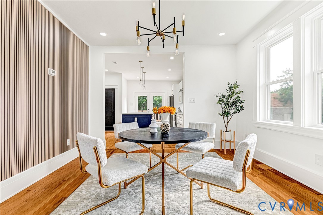 Hardwood flooring, recessed lighting, and a contemporary chandelier