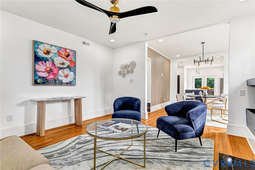 Hardwood flooring, recessed lighting, modern ceiling fan, white wall finishes, open concept design