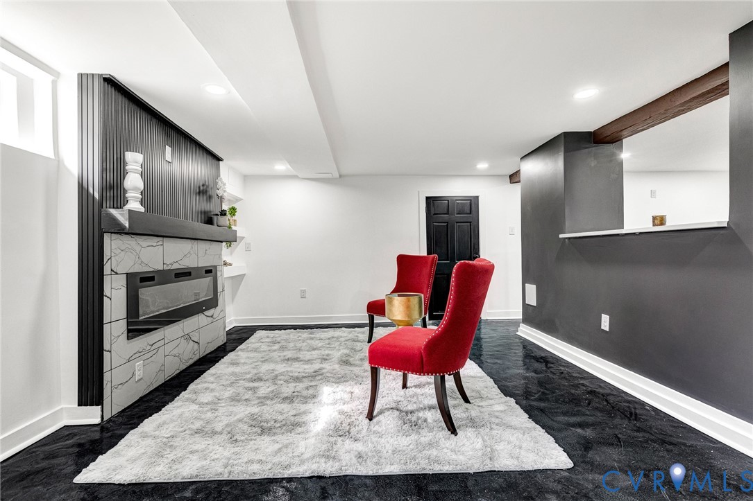 Built-in electric fireplace with stone-look tile surround and dark paneling