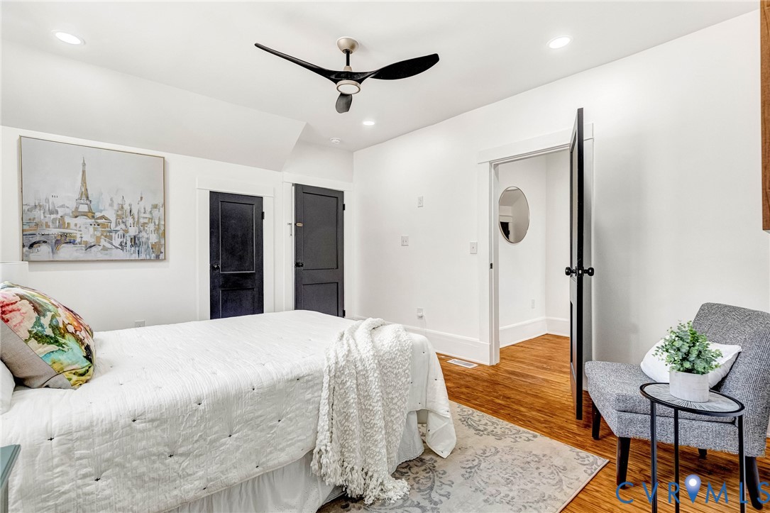 Recessed ceiling lighting, wood-finish flooring, and a contemporary ceiling fan