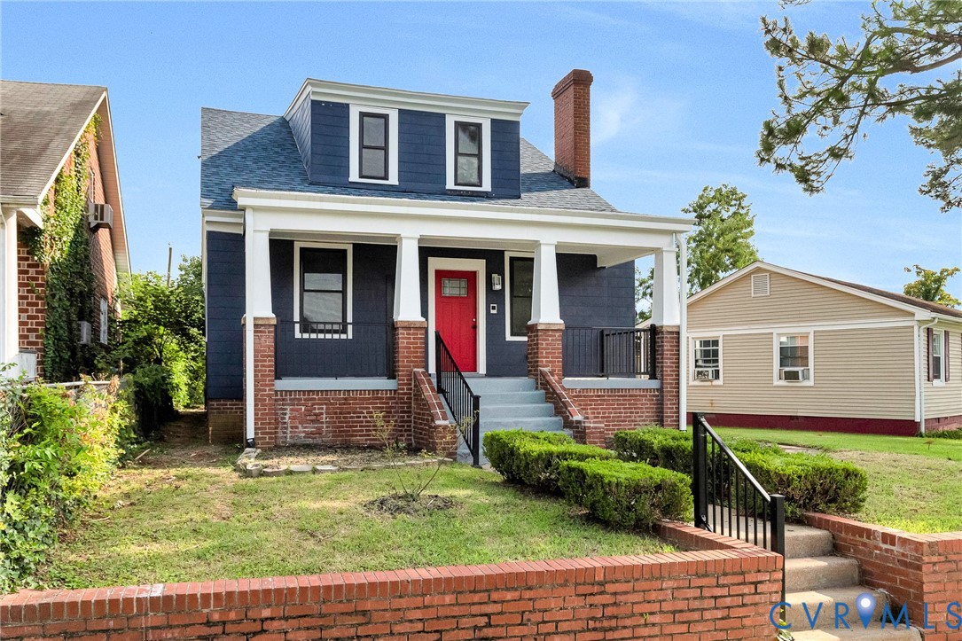 Dormer-style facade with blue siding and white trim
