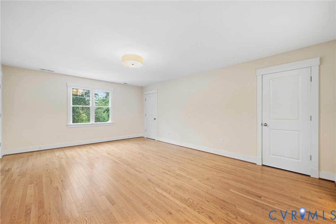 Hardwood flooring, painted walls, white trim, recessed window, flush mount lighting