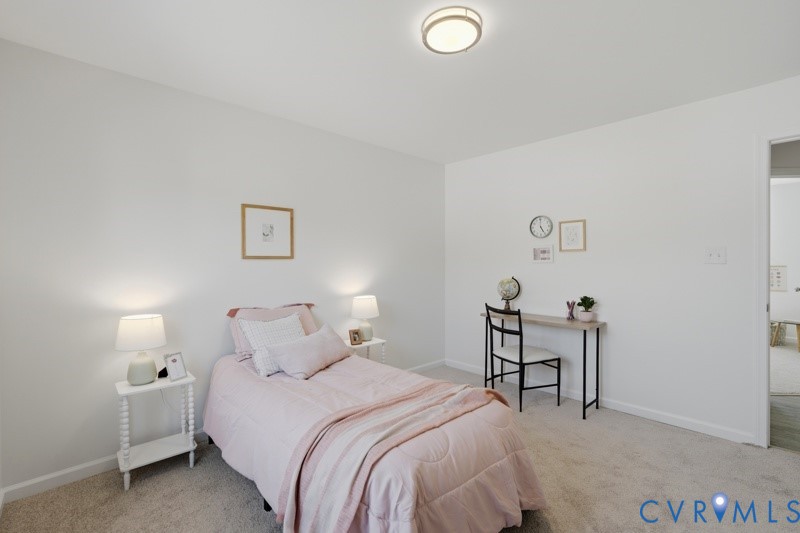 Wall-to-wall carpeting with light-toned walls and a flush-mount ceiling light