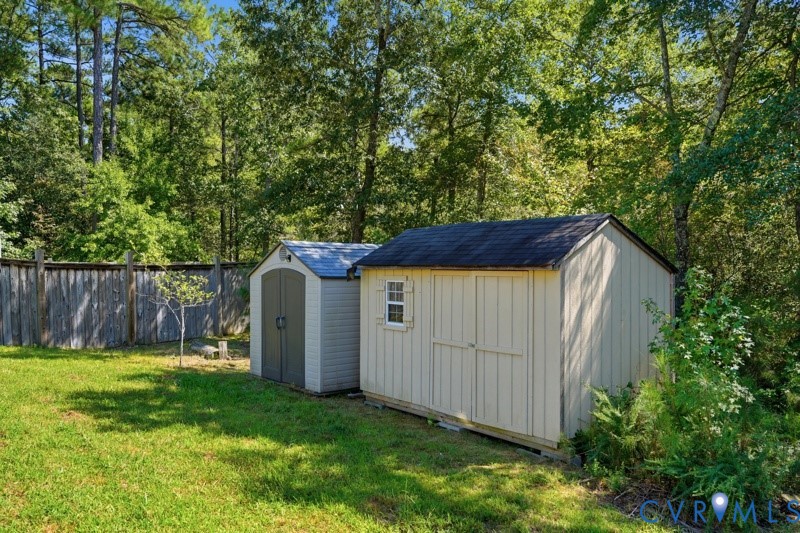 Two detached storage sheds with pitched roofs