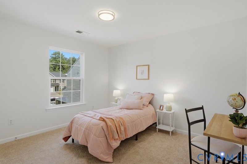Recessed lighting, large window, neutral carpeting, and light-toned wall finishes