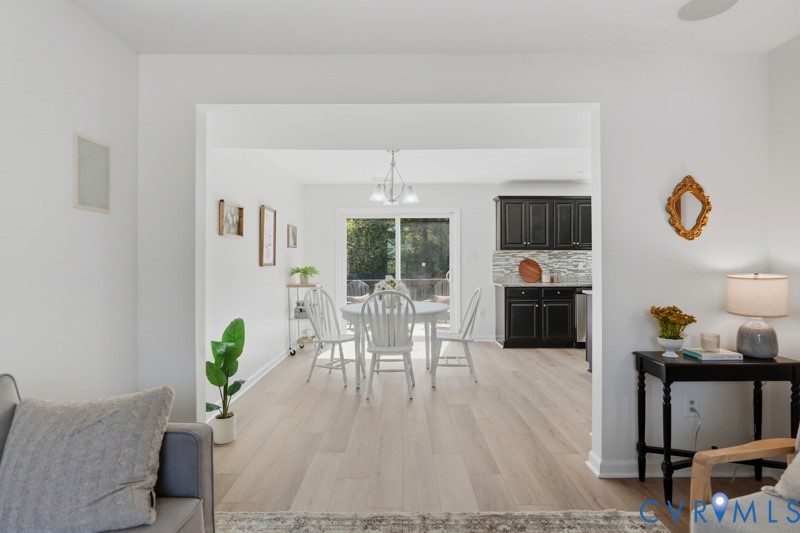Light wood-finish flooring extends through the dining area and kitchen