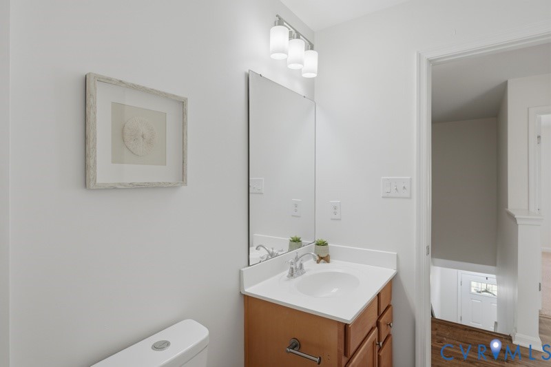 Vanity with integrated sink, chrome faucet, and wood-finish cabinetry