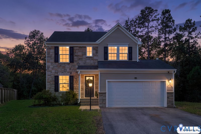 Two-story exterior with stone and siding accents, featuring a prominent two-car garage, multiple windows with black shutters, and a covered entry with a decorative lamp post