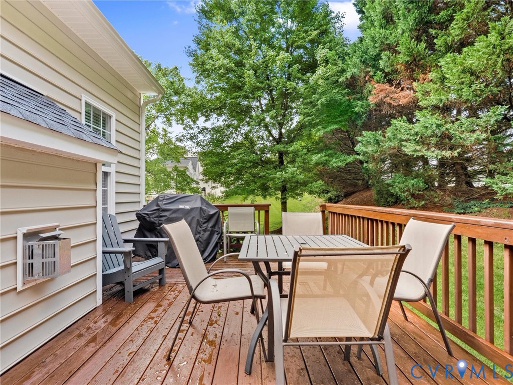 Expansive wood-finish deck with wood railing, offering a private outdoor space