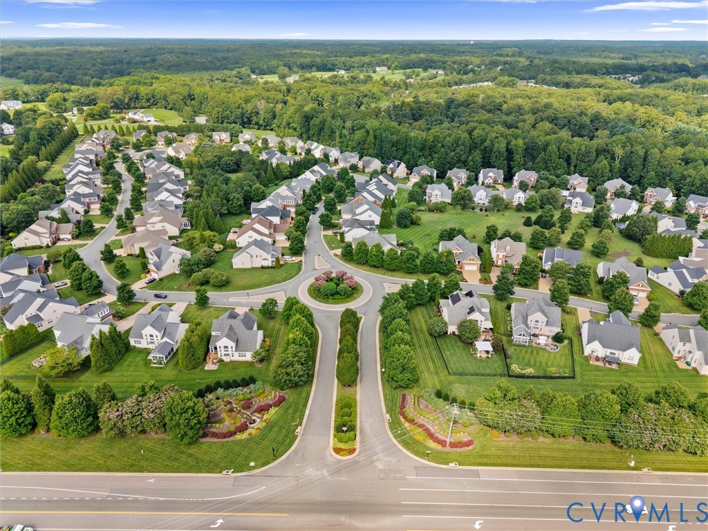 Aerial community layout with a central roundabout and tree-lined streets