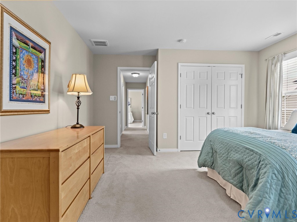 Plush carpet flooring, recessed lighting, and a white six-panel closet door