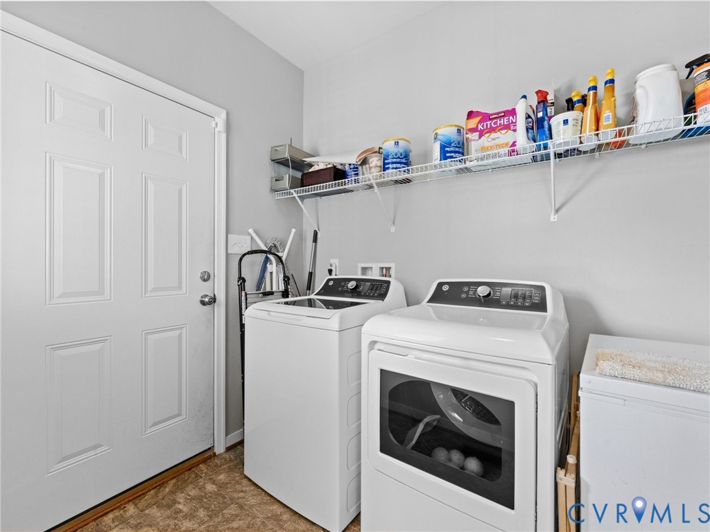 Laundry area featuring wire shelving, a paneled door, and durable flooring