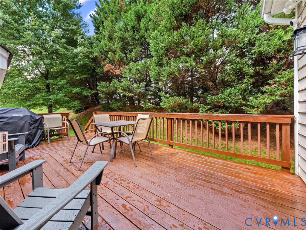 Expansive wood deck with a full wood railing, exterior siding, and integrated exterior lighting