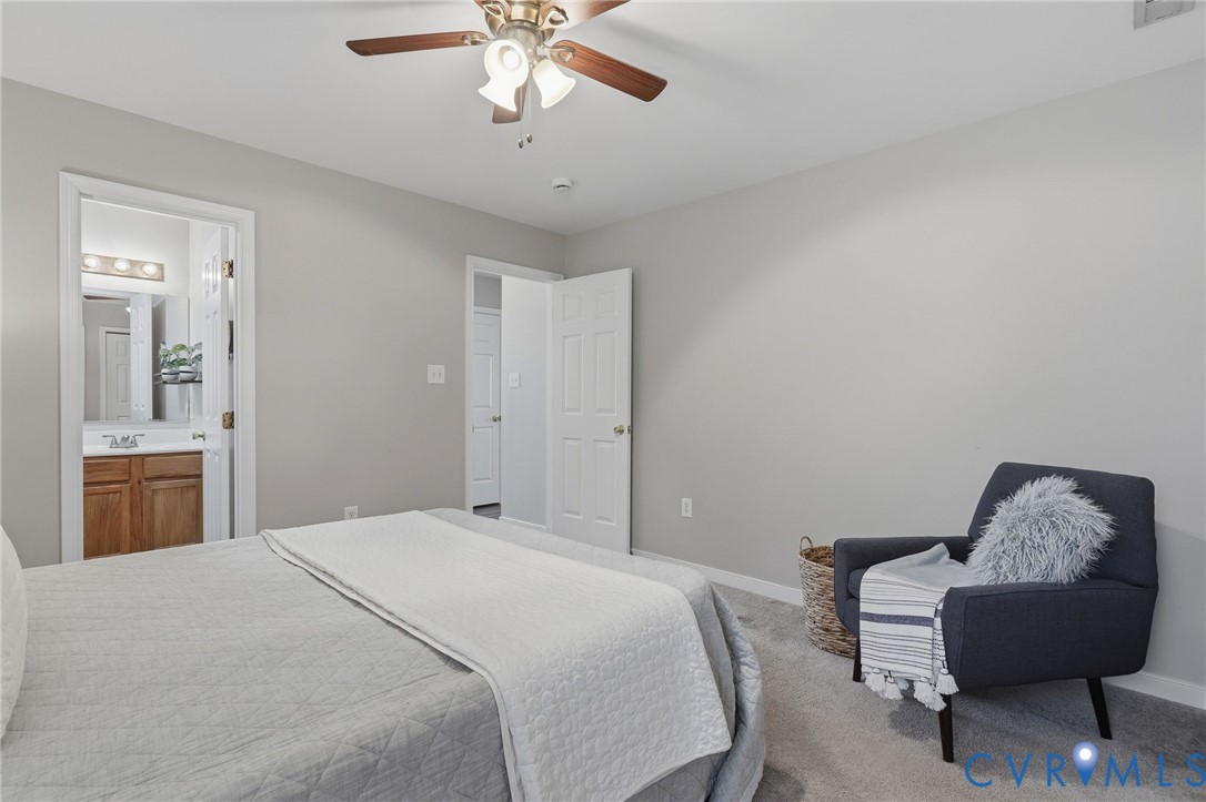 Recessed lighting, ceiling fan with wood-finish blades, and neutral gray walls