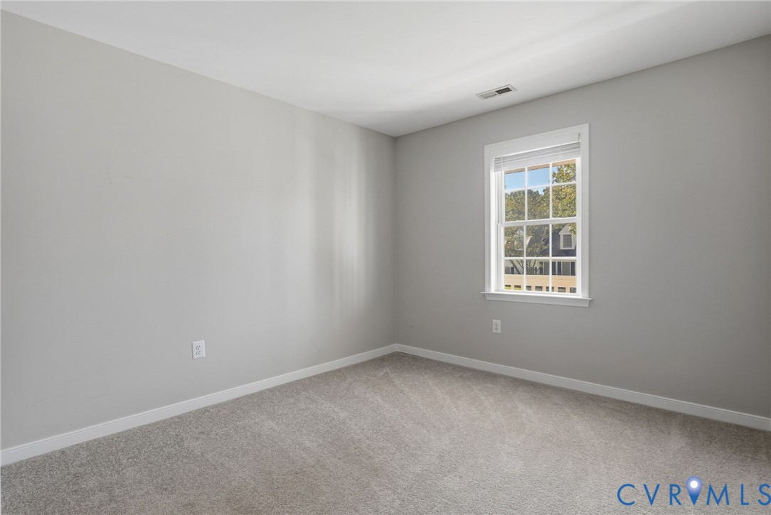 Neutral-toned carpeting paired with light gray wall paint